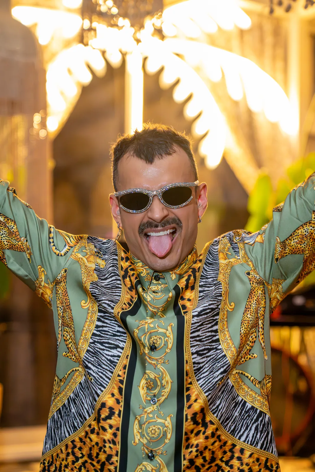 House of Manchic with his arms up behind the decks